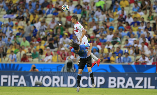 Costa Rica's Cristian Gamboa leaps over Uruguay's Edinson Cavani to win a header during the group D World Cup soccer match between Uruguay and Costa Rica at the Arena Castelao in Fortaleza, Brazil (Photo: AP) Costa Rica's Cristian Gamboa leaps over Uruguay's Edinson Cavani to win a header during the group D World Cup soccer match between Uruguay and Costa Rica at the Arena Castelao in Fortaleza, Brazil (Photo: AP)